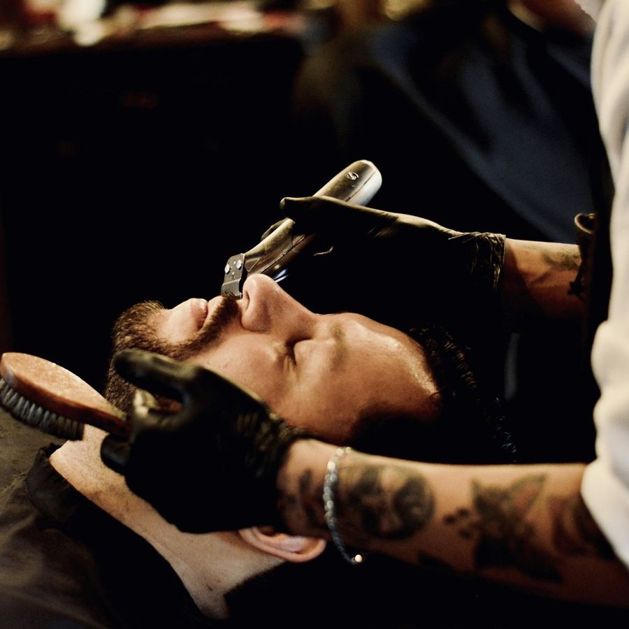 A hot towel and the straight razor at the start of a shave