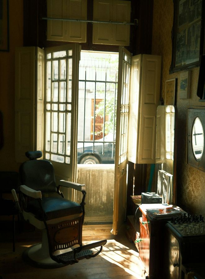The shop doorway standing open with the street beyond it
