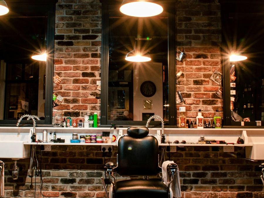 The counter, the mirrors and the lamps along the brick wall