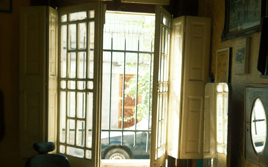 The front doors standing open onto Grant Avenue in full sun